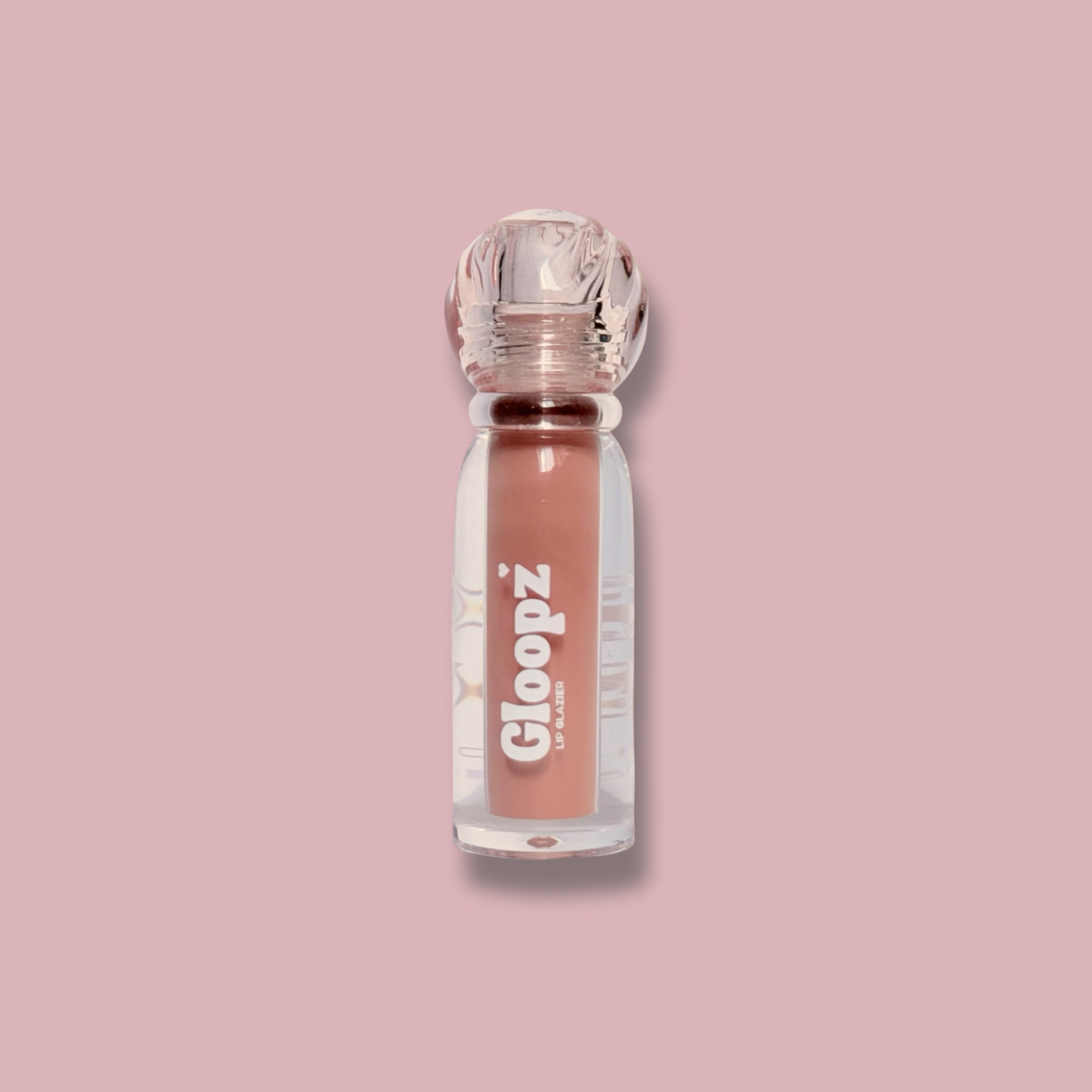Gloopz lip gloss bottle on a pink background