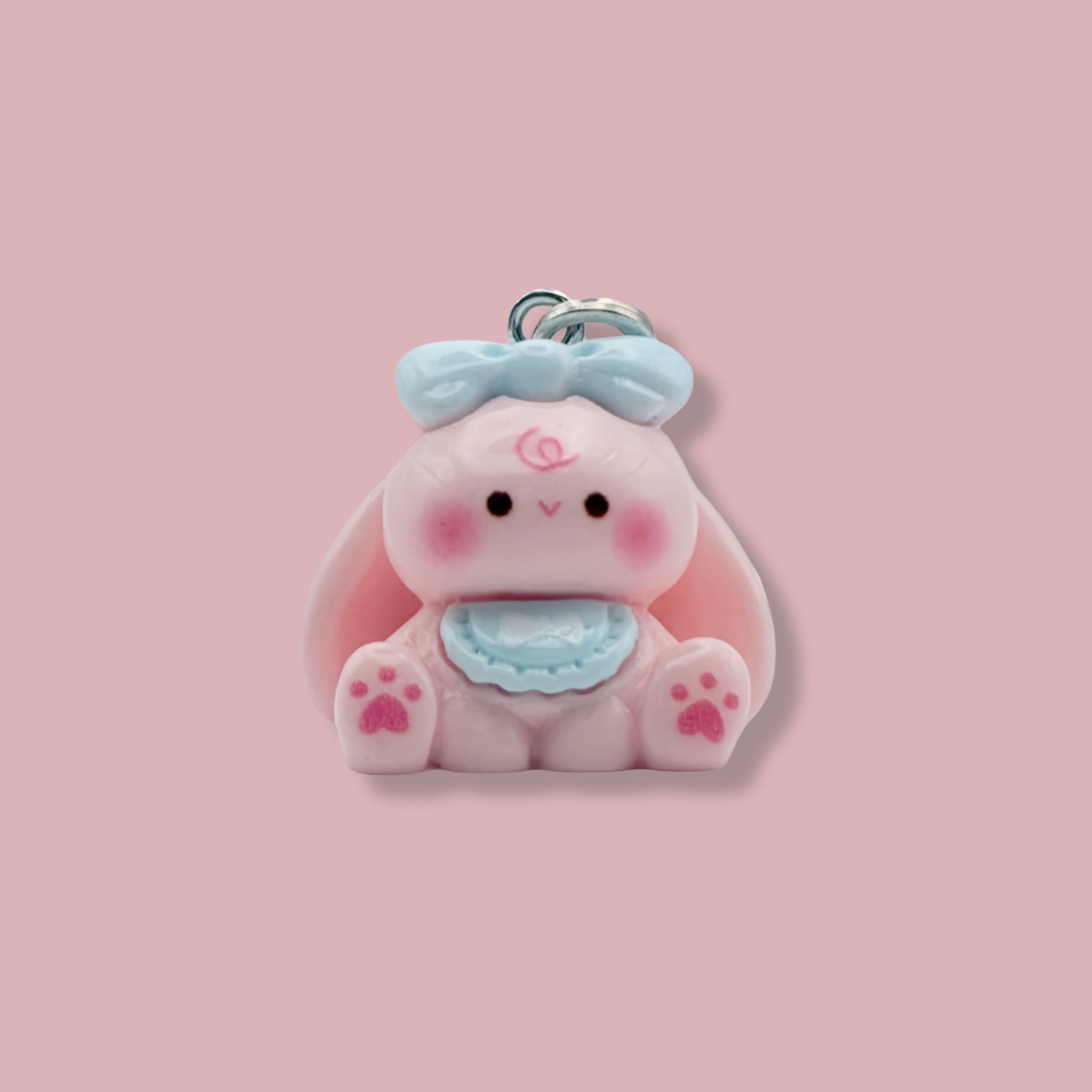 Cute bunny charm with a pink background