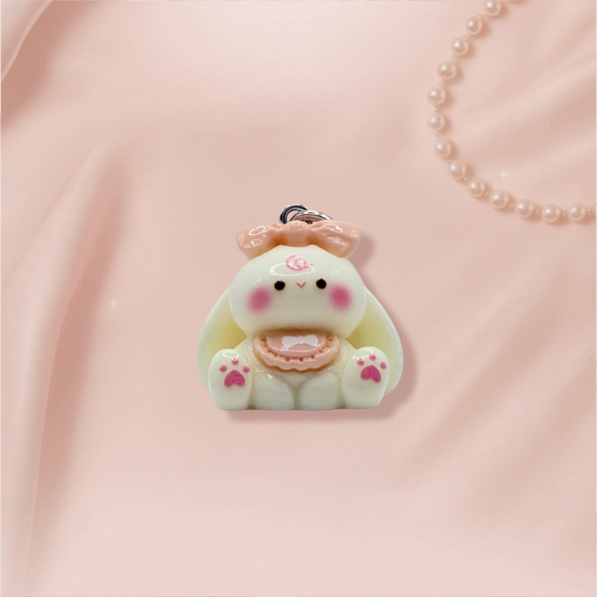 Cute bunny character charm on a pink background