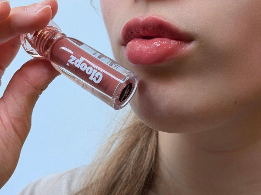Person showing gloopz lipgloss shade with a clear background