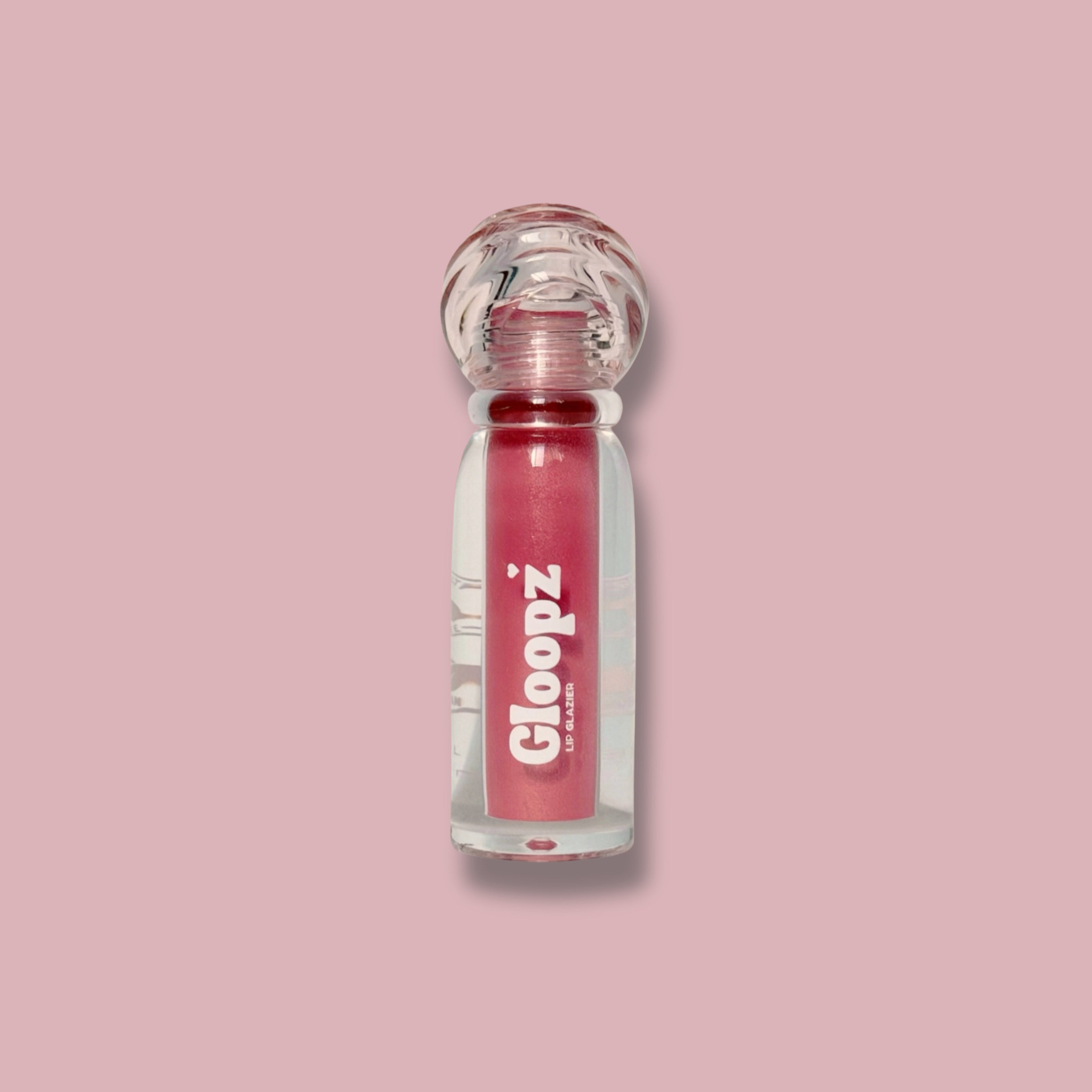Pink lip gloss with 'Gloopz' branding on a pink background
