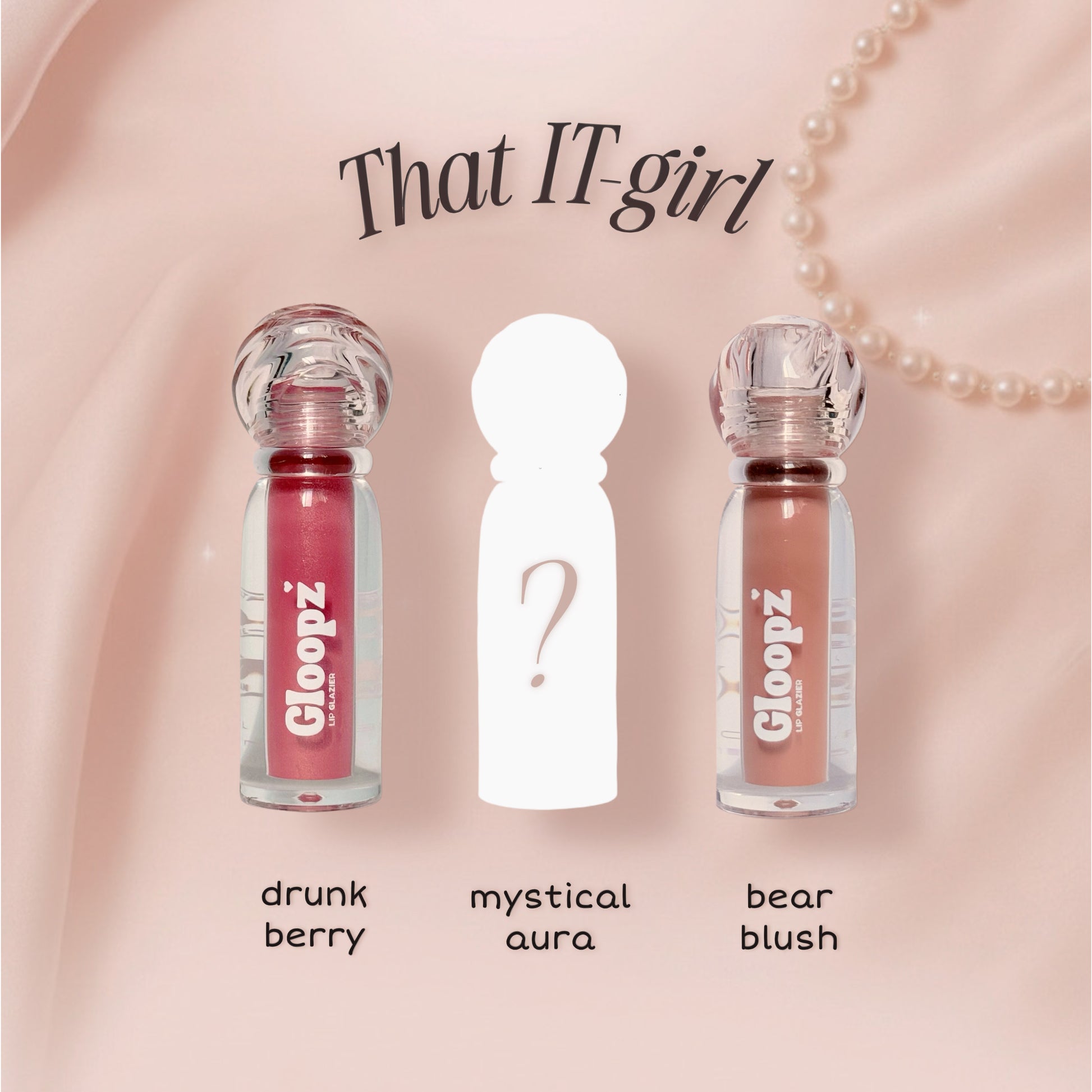 Three lip gloss bottles with labels 'drunk berry', 'mystical aura', and 'bear blush' on a pink background.